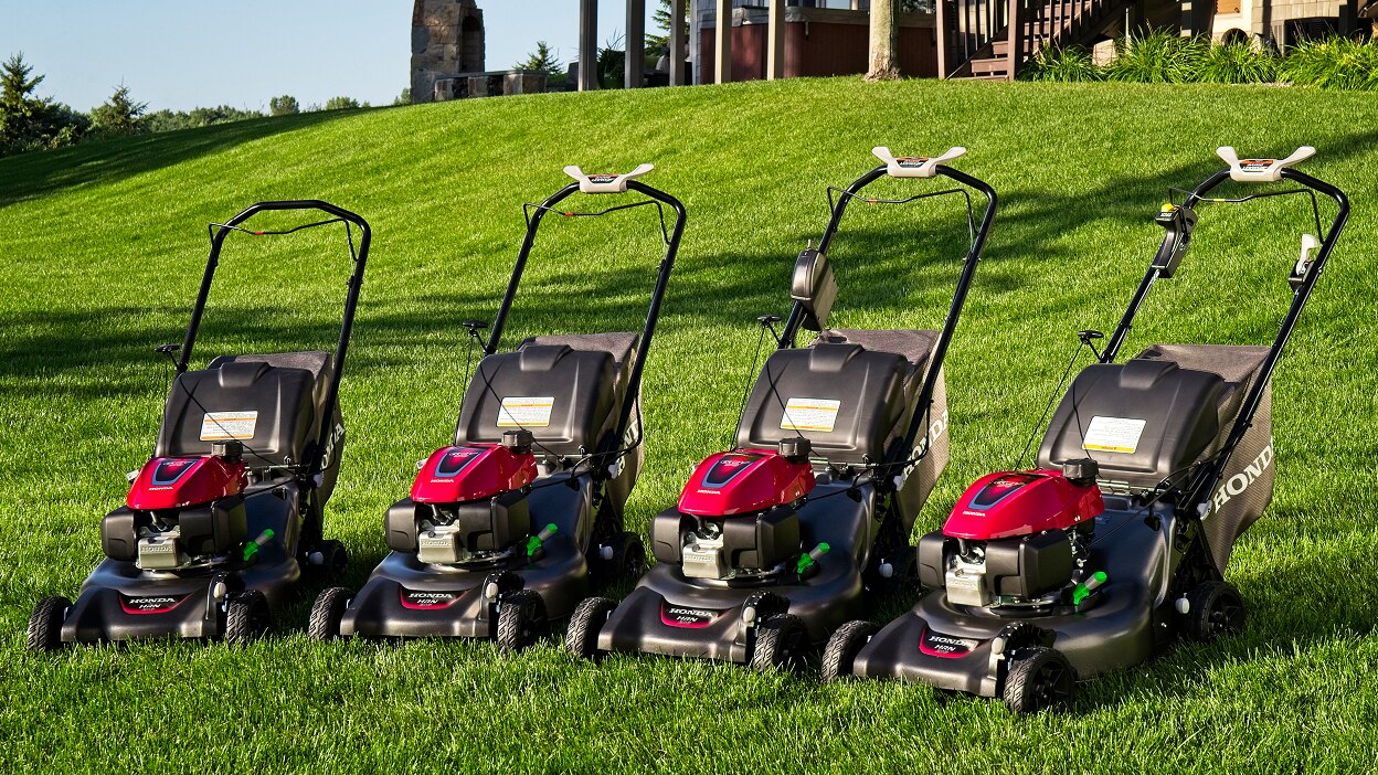 Lifestyle image of Honda Residential Lawn Mowers lineup on grass.