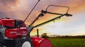Closeup of a tiller in the foreground or a farmers' field at dusk.  